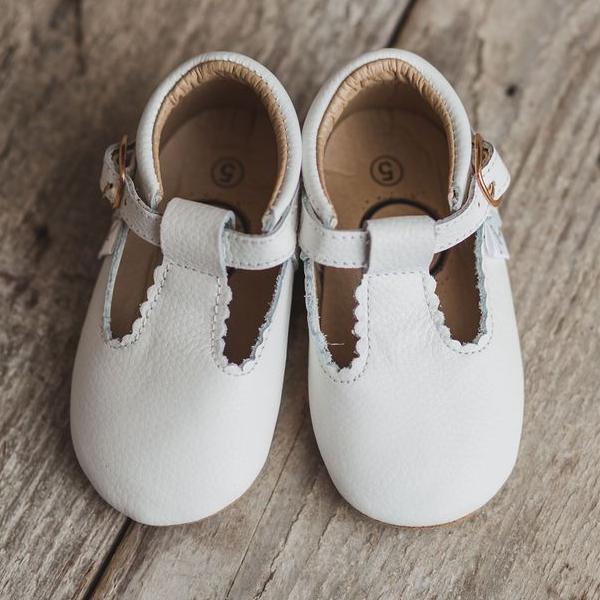  Little Love Bug Co. white t-bar shoes.