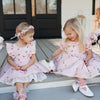 Two girls wearing the  Little Love Bug Co. white t-bar shoes