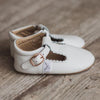 Sides of the  Little Love Bug Co. anti-slip white leather t-bars