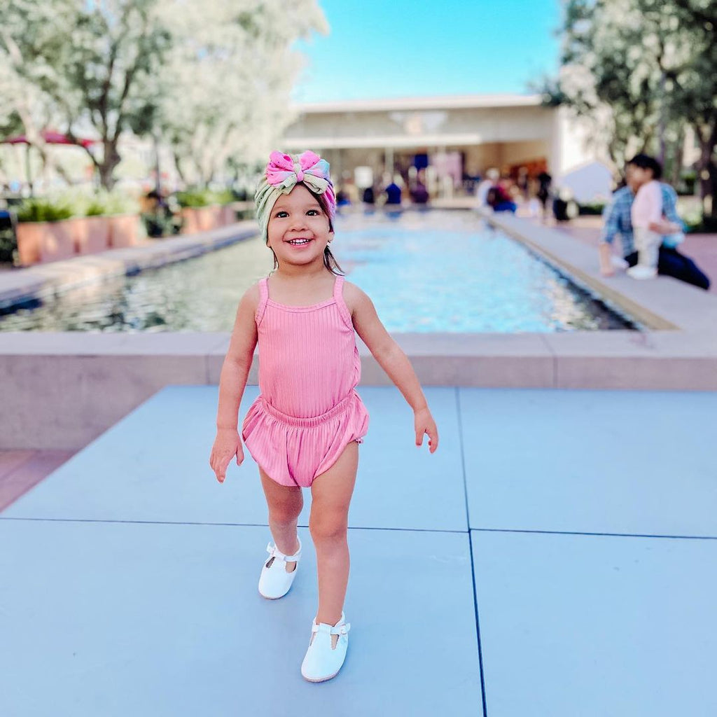 Toddler girl wearing the  Little Love Bug Co. white t-bar shoes.