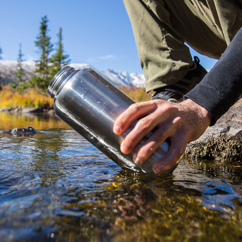 Stream view featuring Klean Kanteen 40oz Wide Water Bottle in Black, built in straw and minimalist design for everyday use.