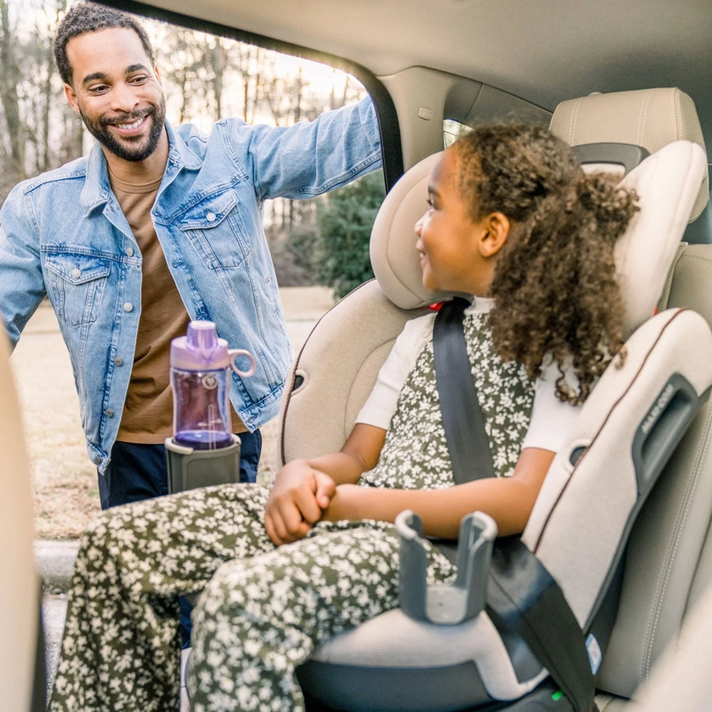 child smiling at father in maxi-cosi 360 rotating car seat