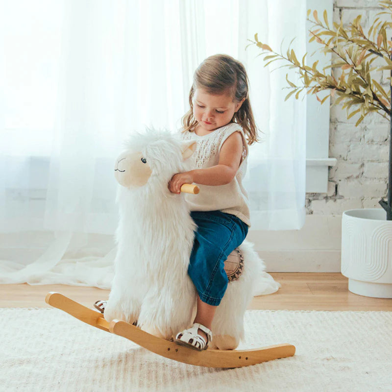 Child riding Wonder & Wise Alpaca Rocker Toy, soft plush rocking animal for imaginative toddler play and coordination