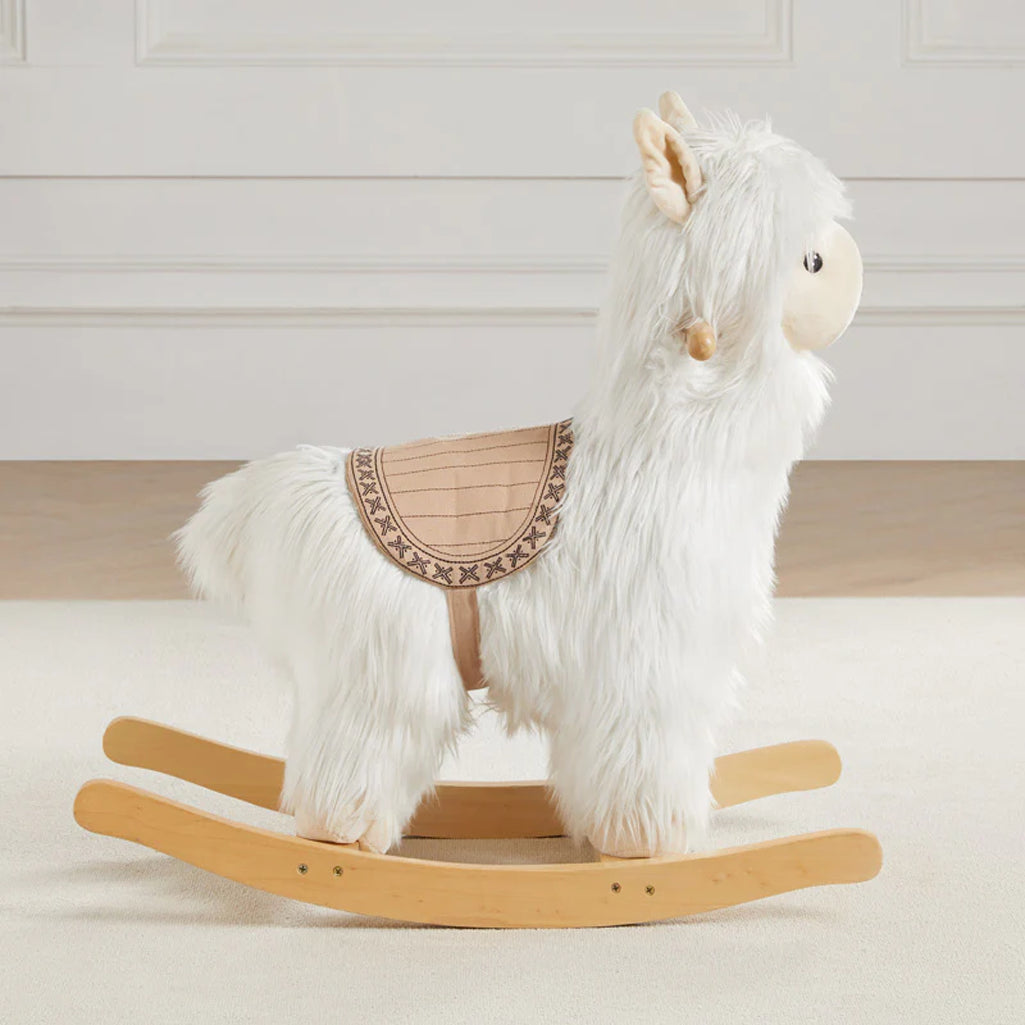 Side view of Wonder & Wise Alpaca Rocker Toy, soft plush alpaca with wooden base and saddle for toddler balance and fun