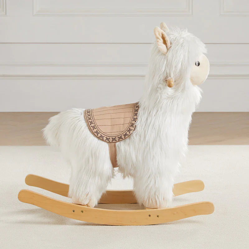 Side view of Wonder & Wise Alpaca Rocker Toy, soft plush alpaca with wooden base and saddle for toddler balance and fun