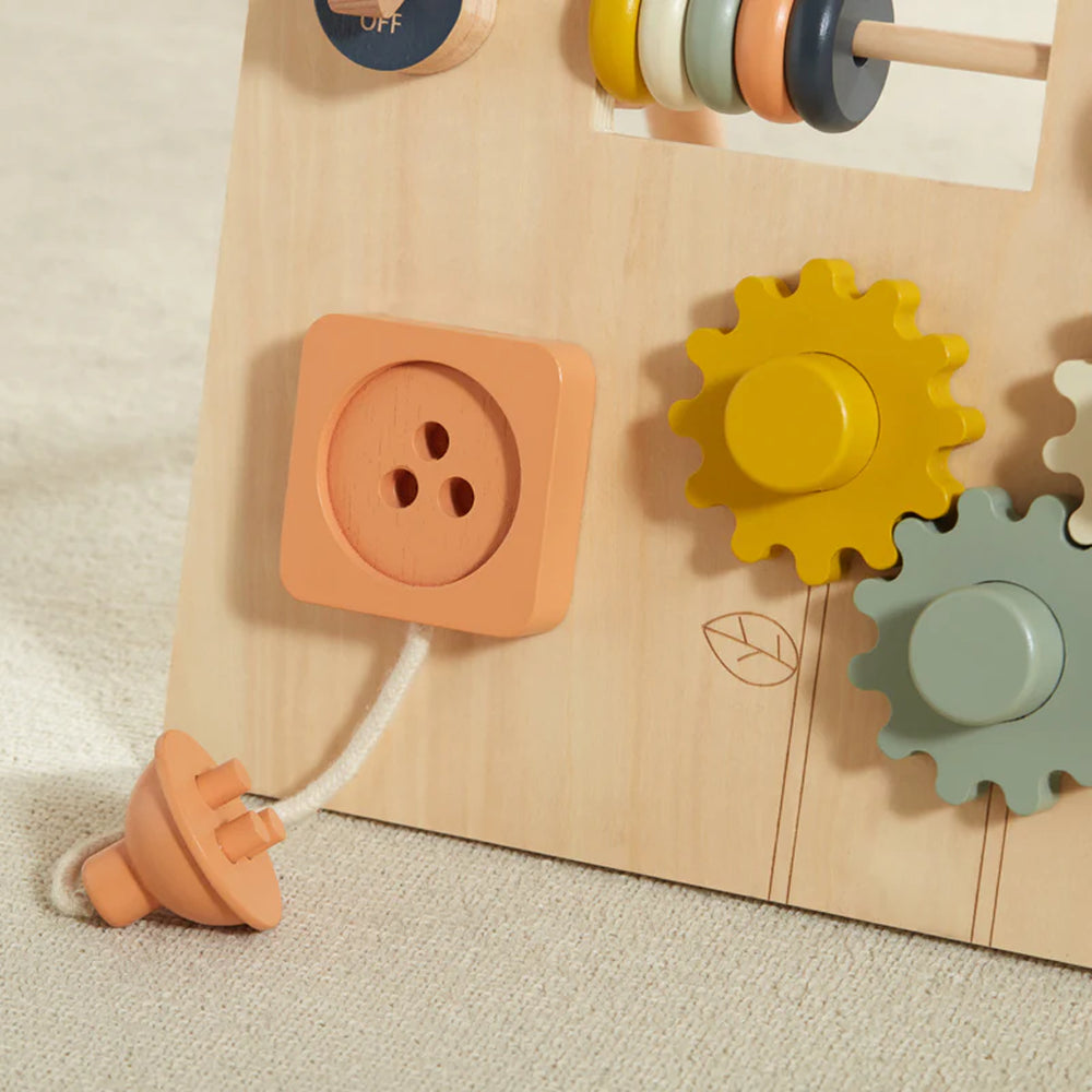 Close-up of Wonder & Wise Busy Board gears, switch, and plug socket for toddler fine motor skill development