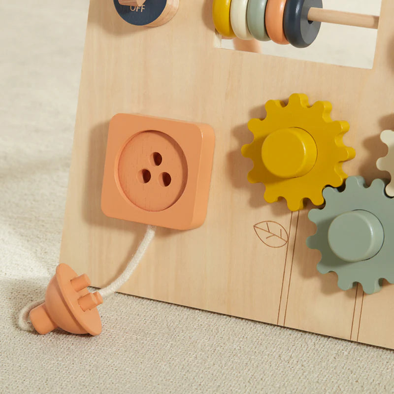 Close-up of Wonder & Wise Busy Board gears, switch, and plug socket for toddler fine motor skill development