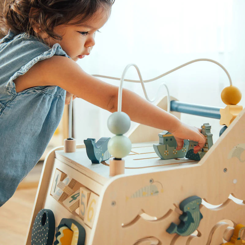 Toddler playing with Wonder & Wise Busy Busy Baby Walker side panel gears and bead maze, Montessori sensory toy