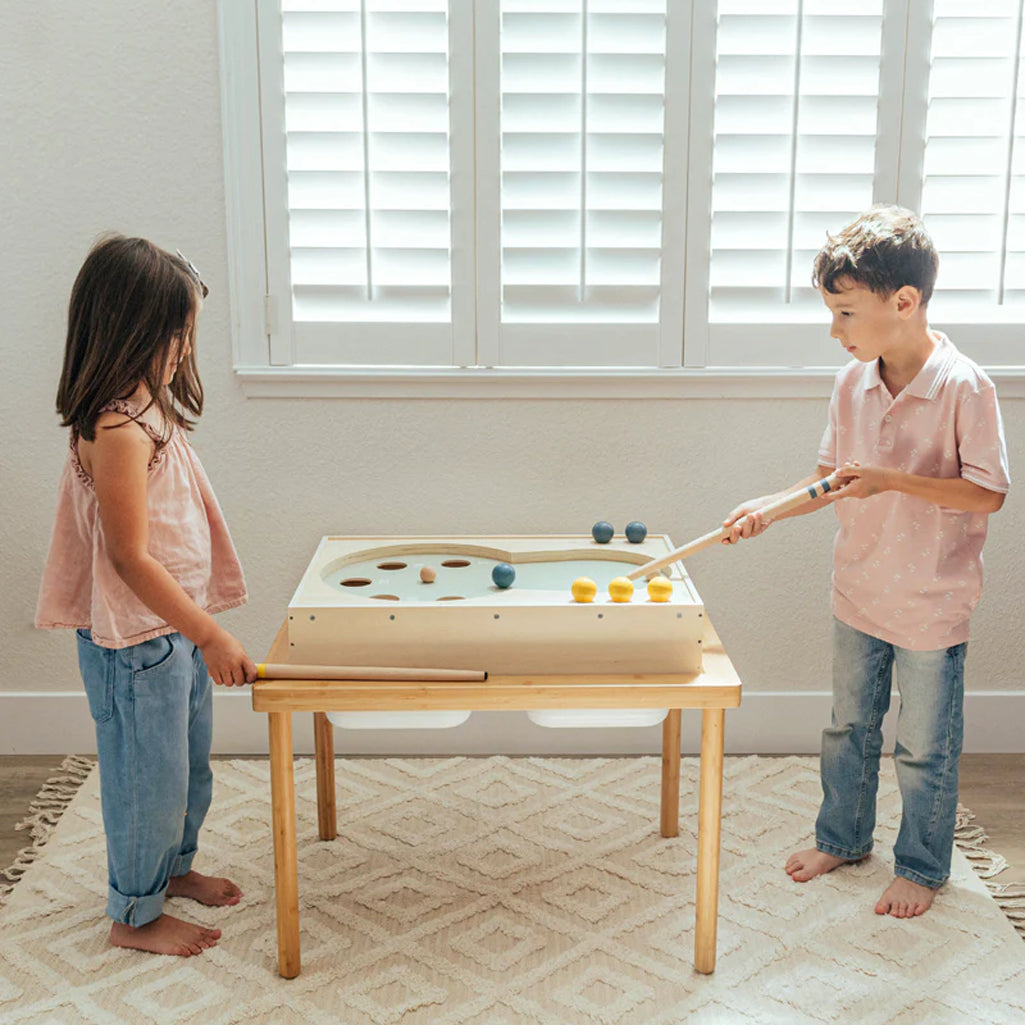 two kids playing pool game on wooden wonder and wise billards table 