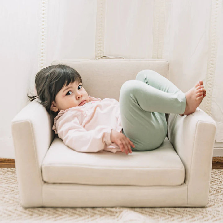 toddler sitting on natural wonder and wise square chair with detachable activity table 