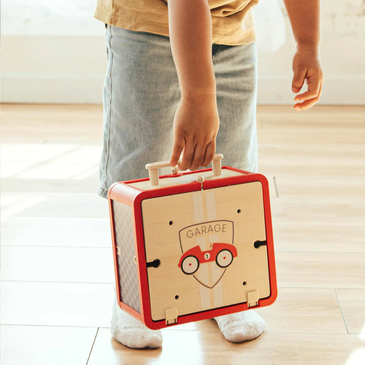 Take with Me Garage closed as carry case held by child showing portable design