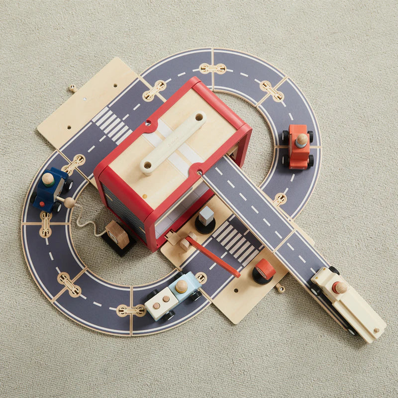 Aerial view of Take with Me Garage with road mat, vehicles, and accessories laid out on grey surface