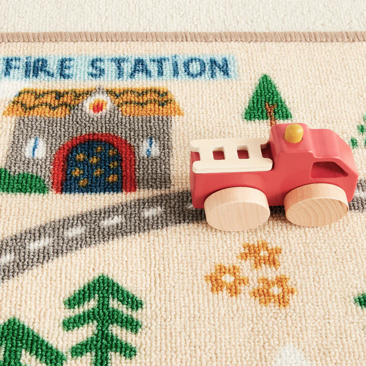 Wonder & Wise Around Town Play Mat fire station detail with wooden fire truck, city-themed educational play set for toddlers