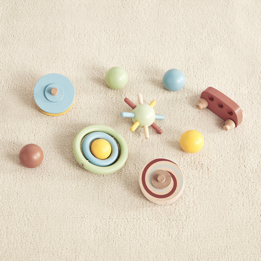 group of colorful wooden toys that are included in the wonder and wise tumble track gravitational learning toy 