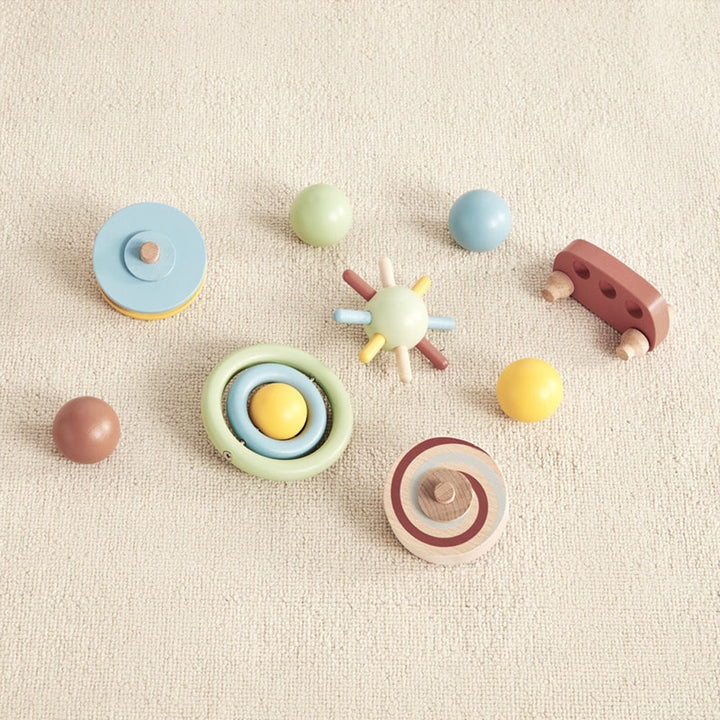 group of colorful wooden toys that are included in the wonder and wise tumble track gravitational learning toy 