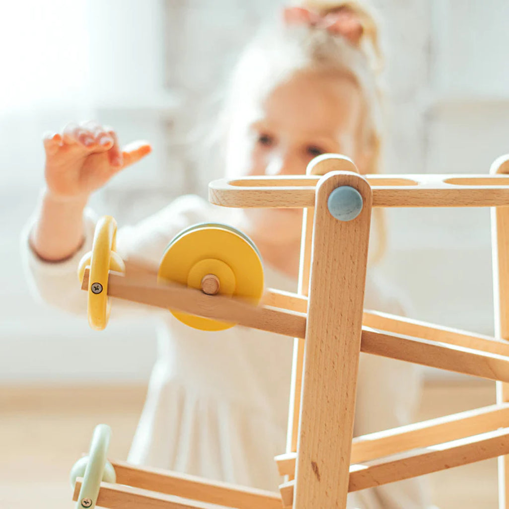 toddler playing with wonder and wise toy car and marble tumble track 