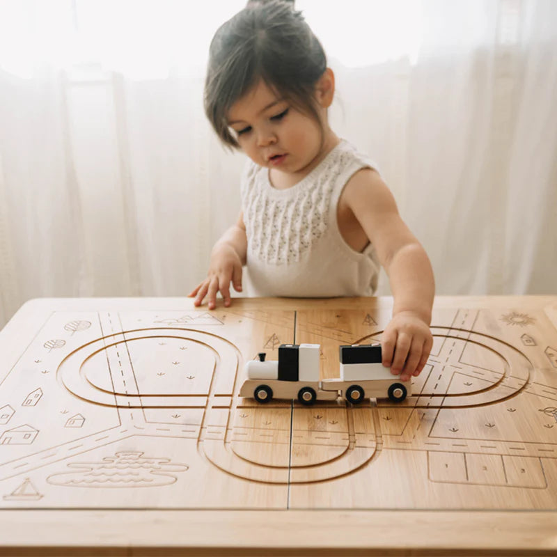 child playing with wooden train table top wonder and wise learning table for science learning