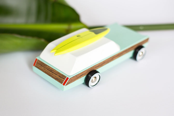 Lifestyle scene with Plantoys Woodie Redux toy car, perfect as a big toy car for kids.