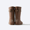 goumikids Sienna Muddies Rain Boots Children's Rubber Boots. Brown rubber rain boots for children. Goumi label debossed in white rectangle. Adjustable buckle on back of boot. Back view.