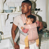 dad holding baby in kitchen baby bjorn best baby carrier mini pink