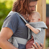 dad outdoors with baby in baby bjorn baby carrier mini in grey