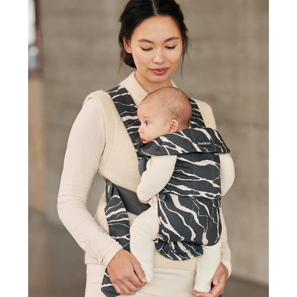 mom looking down at infant in babybjorn baby carrier mini