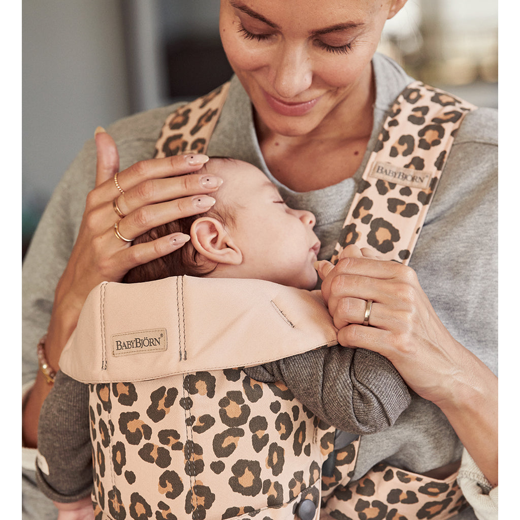 mother smiling with sleeping baby in babybjorn baby carrier mini