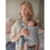 mom reflecting with newborn in grey free babybjorn carrier