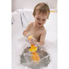 Child using the yellow bubble bath whisk