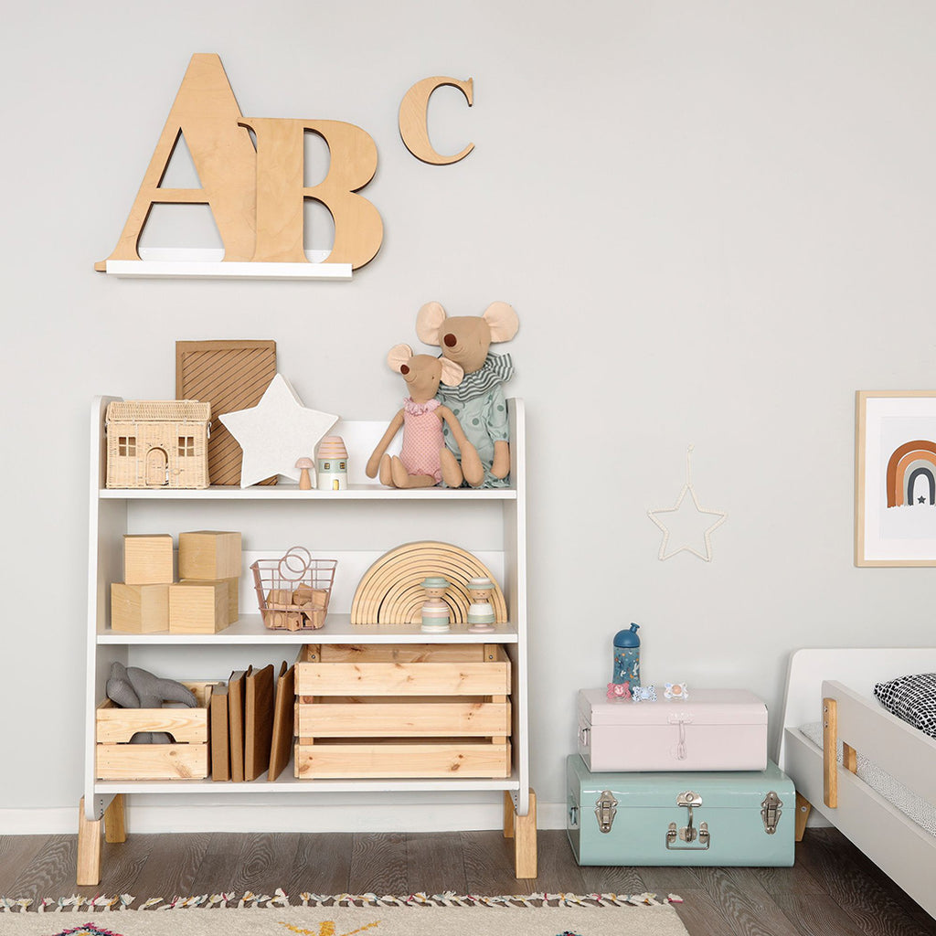 dadada Muse Bookshelf shown in child's room with various items on shelf.