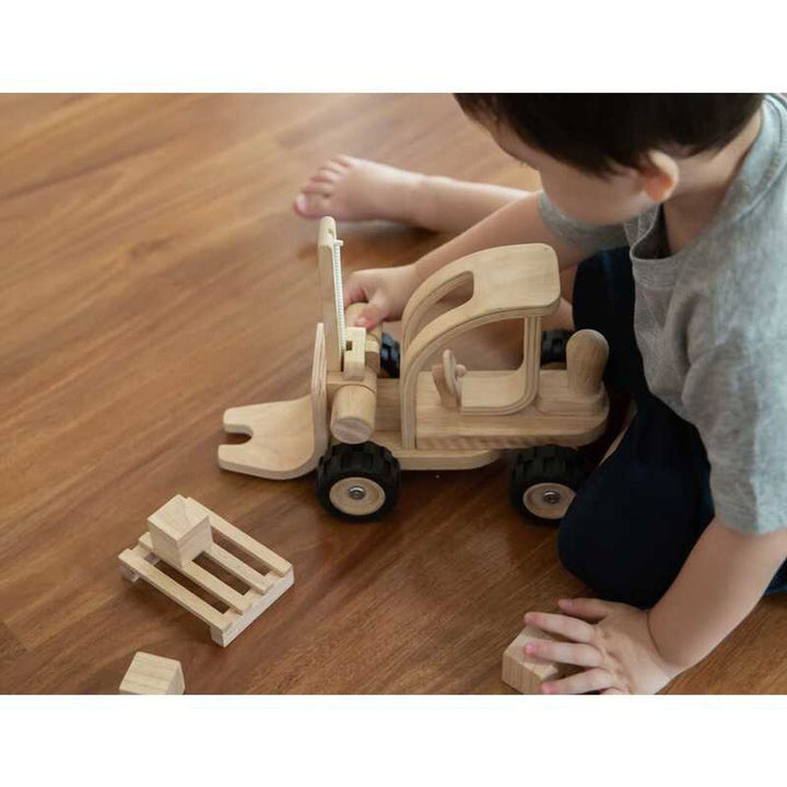 Best toys for kids, featuring a wooden fire truck toy by PlanWood, made with natural materials.