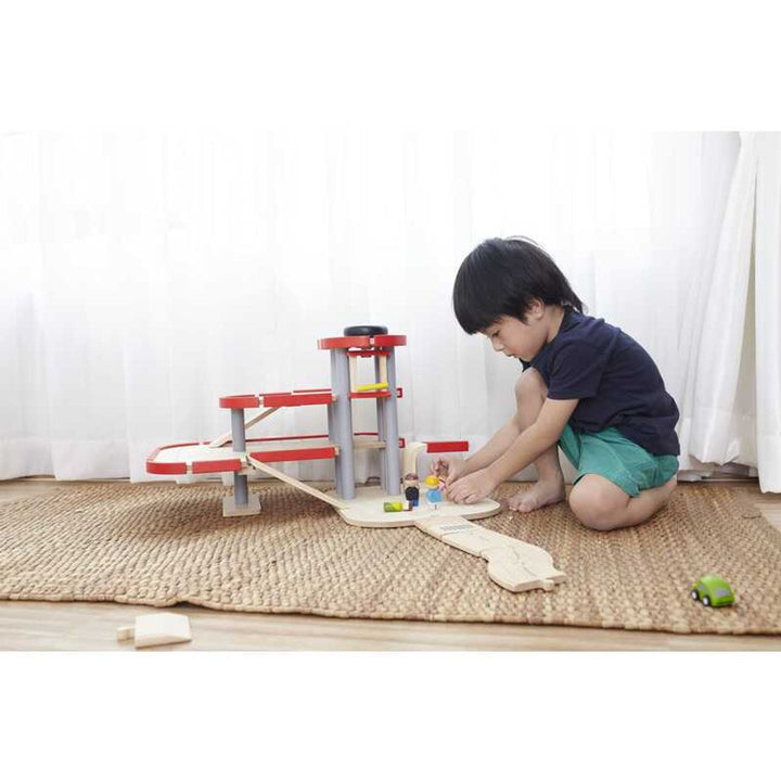 Designed for imaginative fun, Plantoys Parking Garage is a Montessori toy for young children.