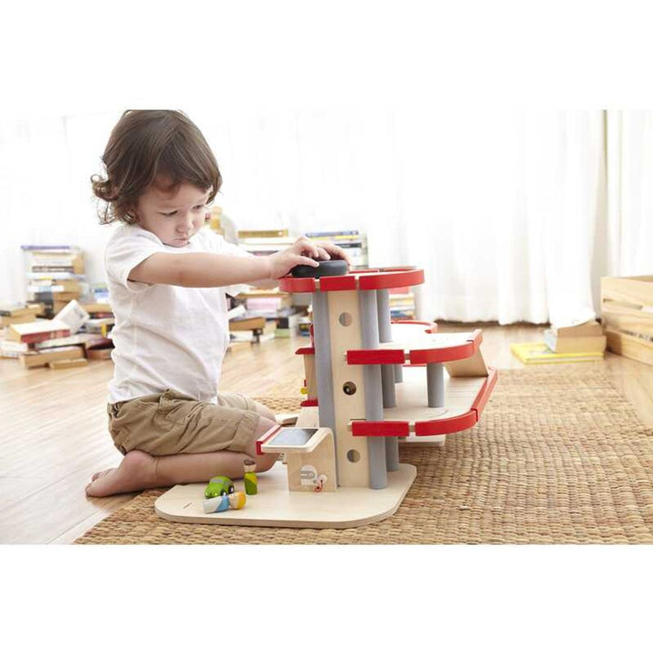 With Plantoys Parking Garage, an educational toy, children develop motor skills and coordination.