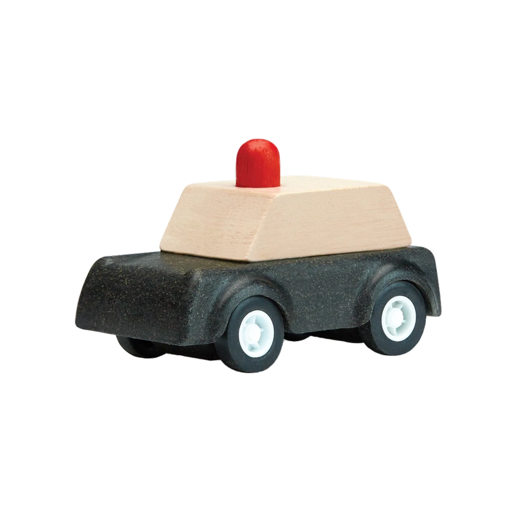 A Plan Toys wooden police car for children, part of a collection of wooden vehicles.