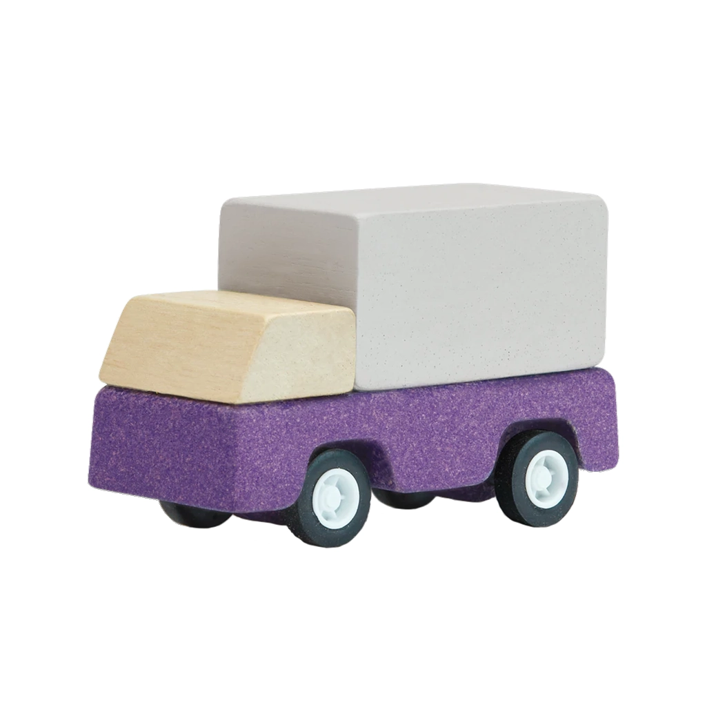A purple Plan Toys delivery truck, made from wood and designed for children's imaginative transport play.