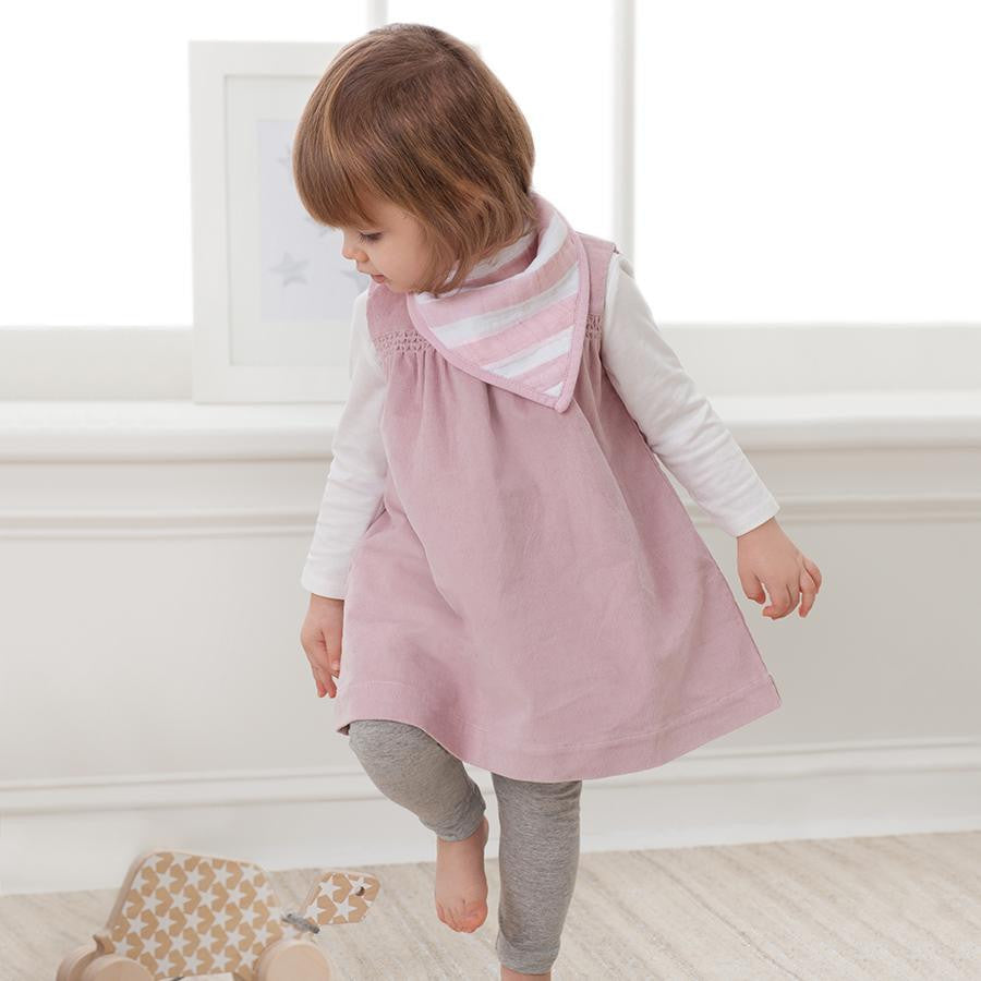 Toddler Wearing Pink aden + anais Classic Bandana Bibs, showcasing durability and charm for growing kids.