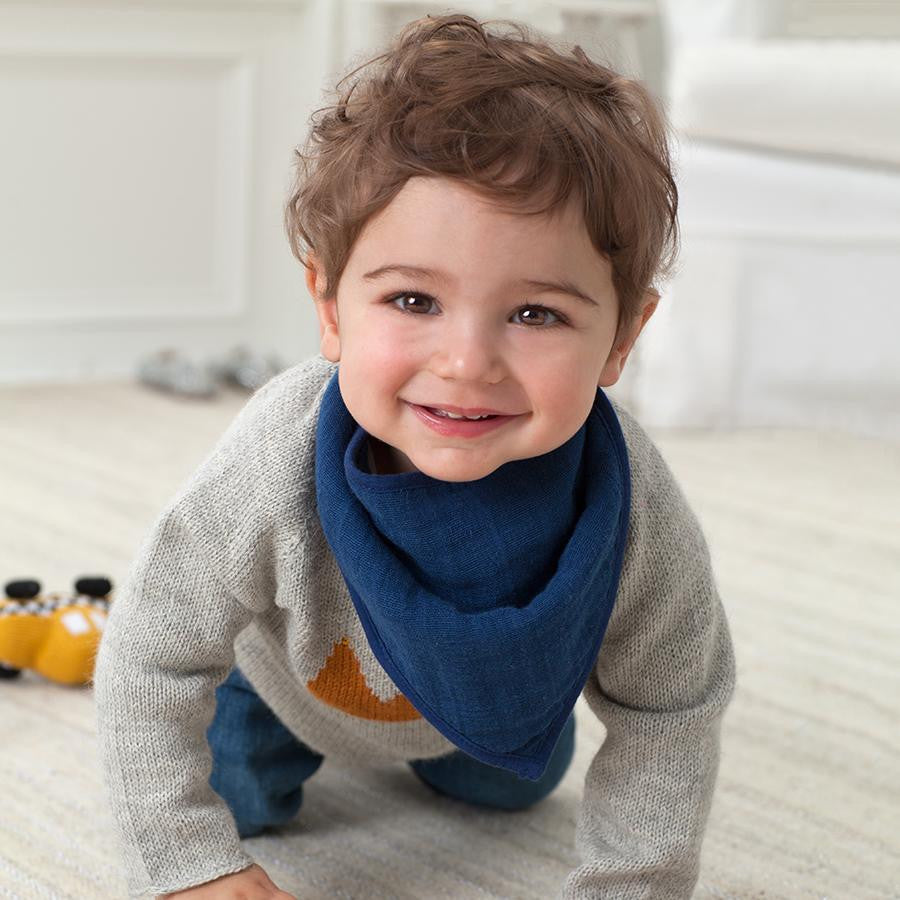 aden + anais Classic Bandana Bib on a Crawling Baby, keeping little ones clean while they explore.