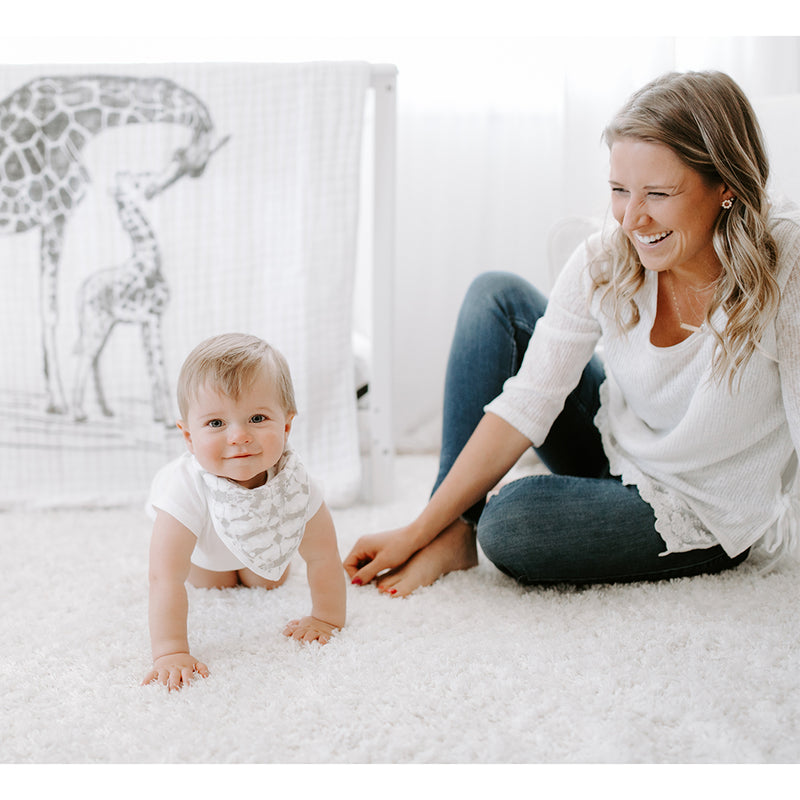 Mom with Baby Wearing aden + anais Classic Bandana Bib, a practical solution for busy parents.