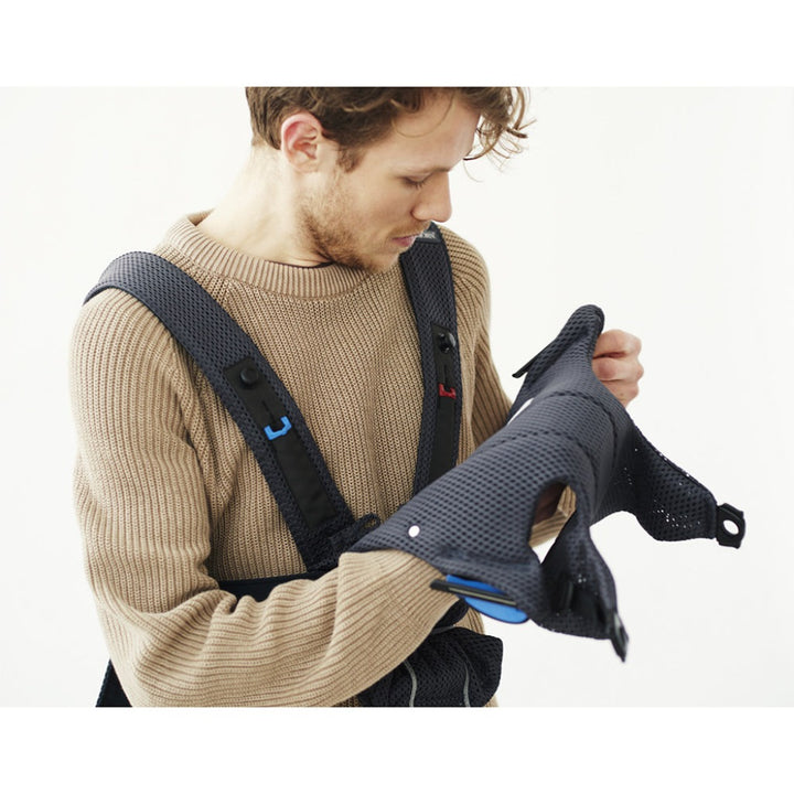 dad putting on babybjorn baby carrier mini in anthracite