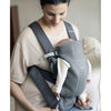 mom looking down at atinfant in baby bjorn infant carrier mini