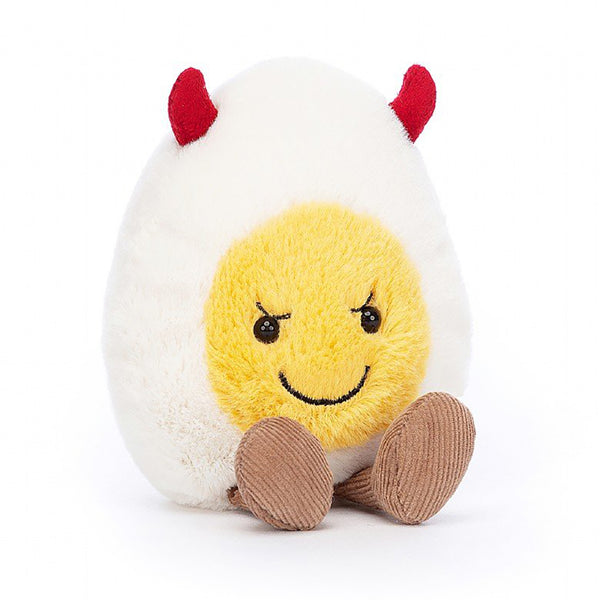 Jellycat Amuseable Devilled Egg Children's Stuffed Animal Toy. White and yellow egg plushie with tiny red horns and brown feet. Black stitched smile and black button eyes. 