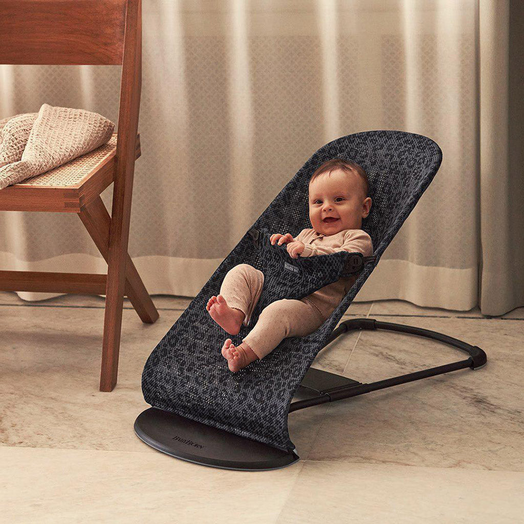 baby lounging in babybjorn bouncer bliss anthracite leopard