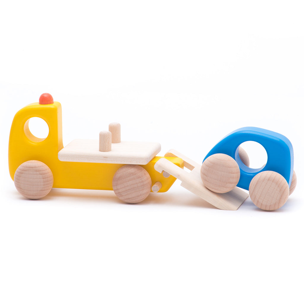 Wooden breakdown lorry by BAJO, designed for imaginative car repair play.
