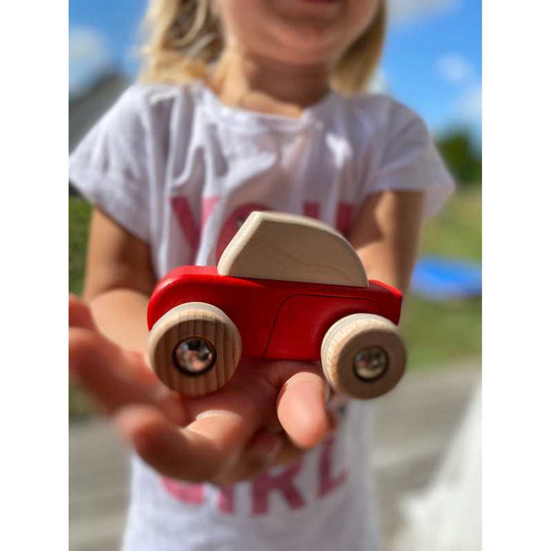 A Bajo wooden car toy designed for children, ideal for hands-on imaginative play and role-playing.