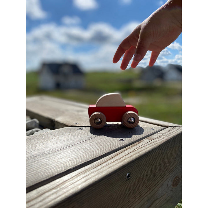 A set of Bajo wooden cars for kids, perfect for exploring pretend driving and car play.