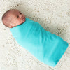 Baby Swaddled in K'tan Newborn Swaddle in Teal