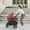 Woman Walking with Uppababy Cruz Stroller with Bassinet Accessory in Lucy
