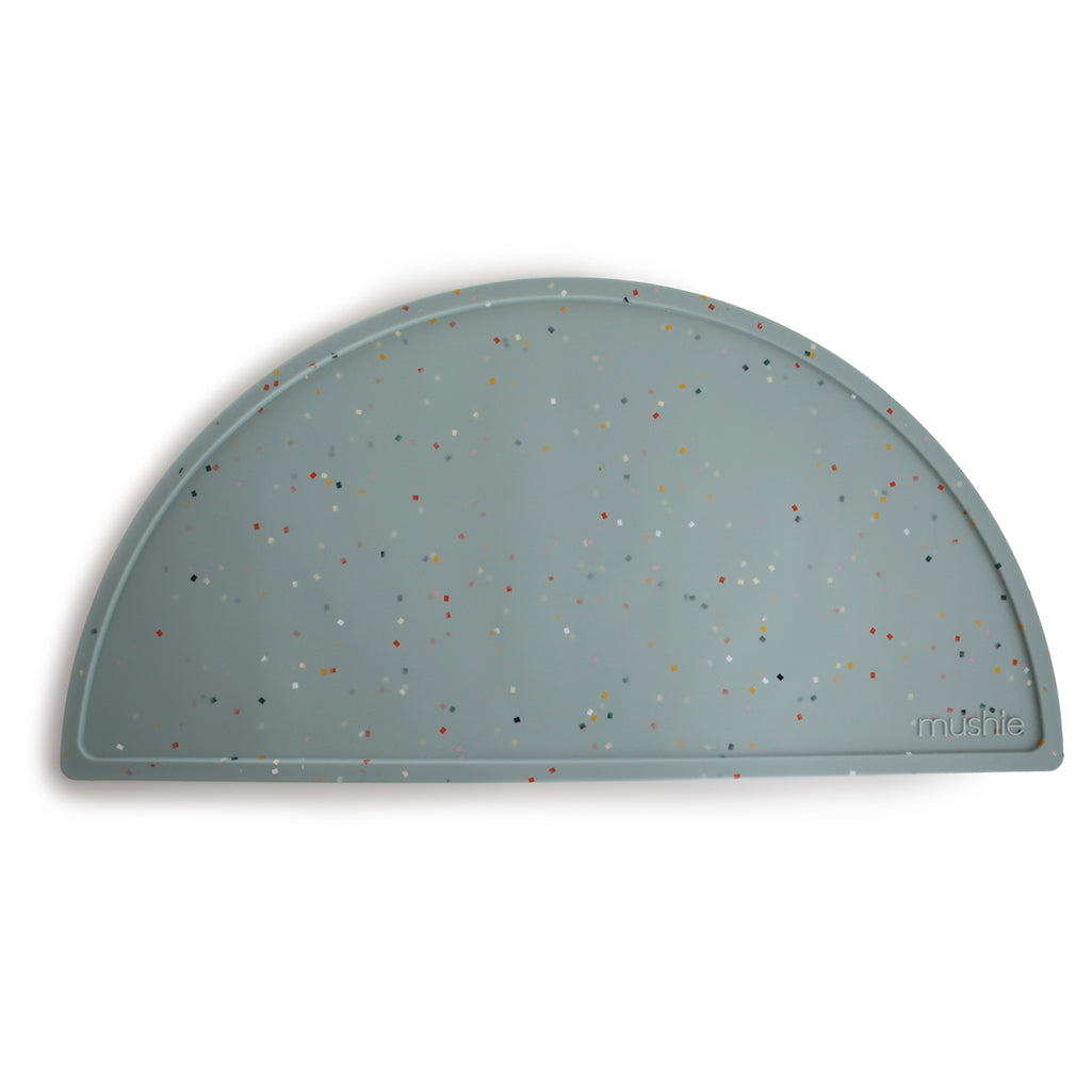 Mushie Silicone Placemat in Blue Confetti A fun confetti design in shades of blue to bring joy and color to mealtime