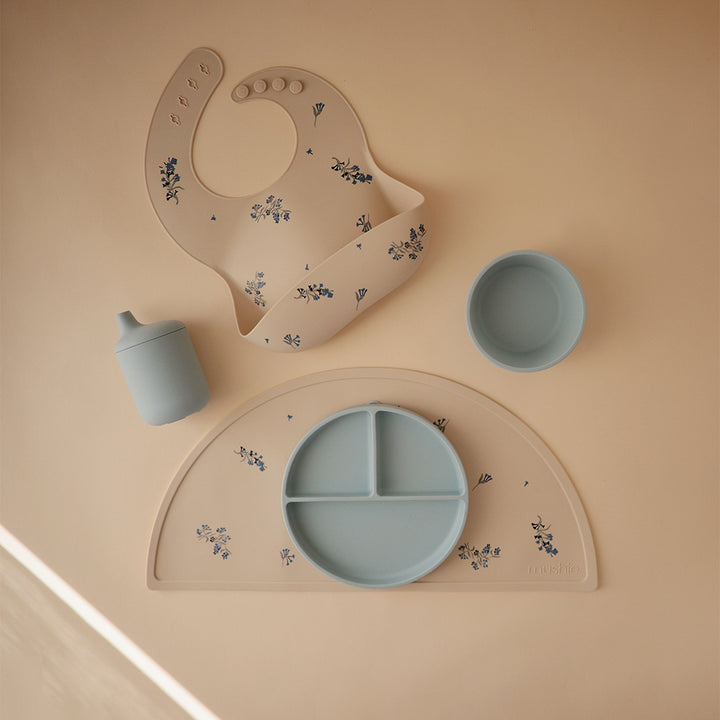 Mushie Silicon Placemat in Lilac Flowers Soft lilac flower prints adding a touch of sweetness to any table