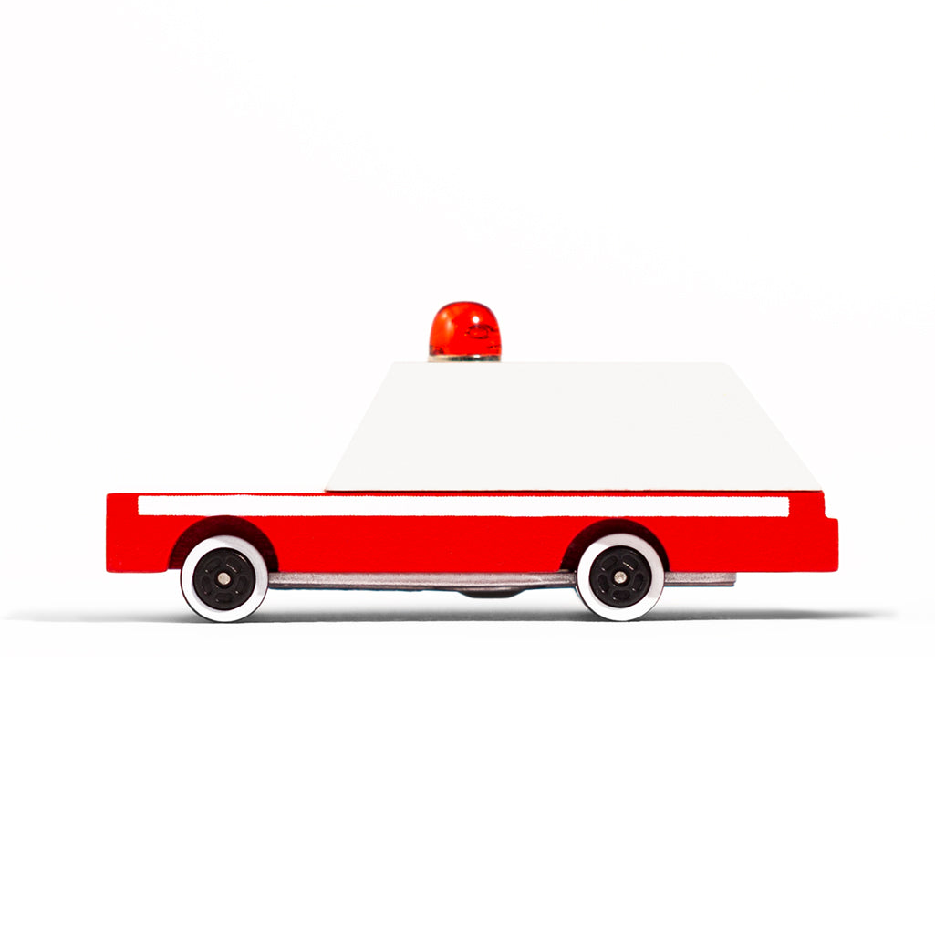 Side profile of Candylab wooden toy ambulance featuring a classic red and white design